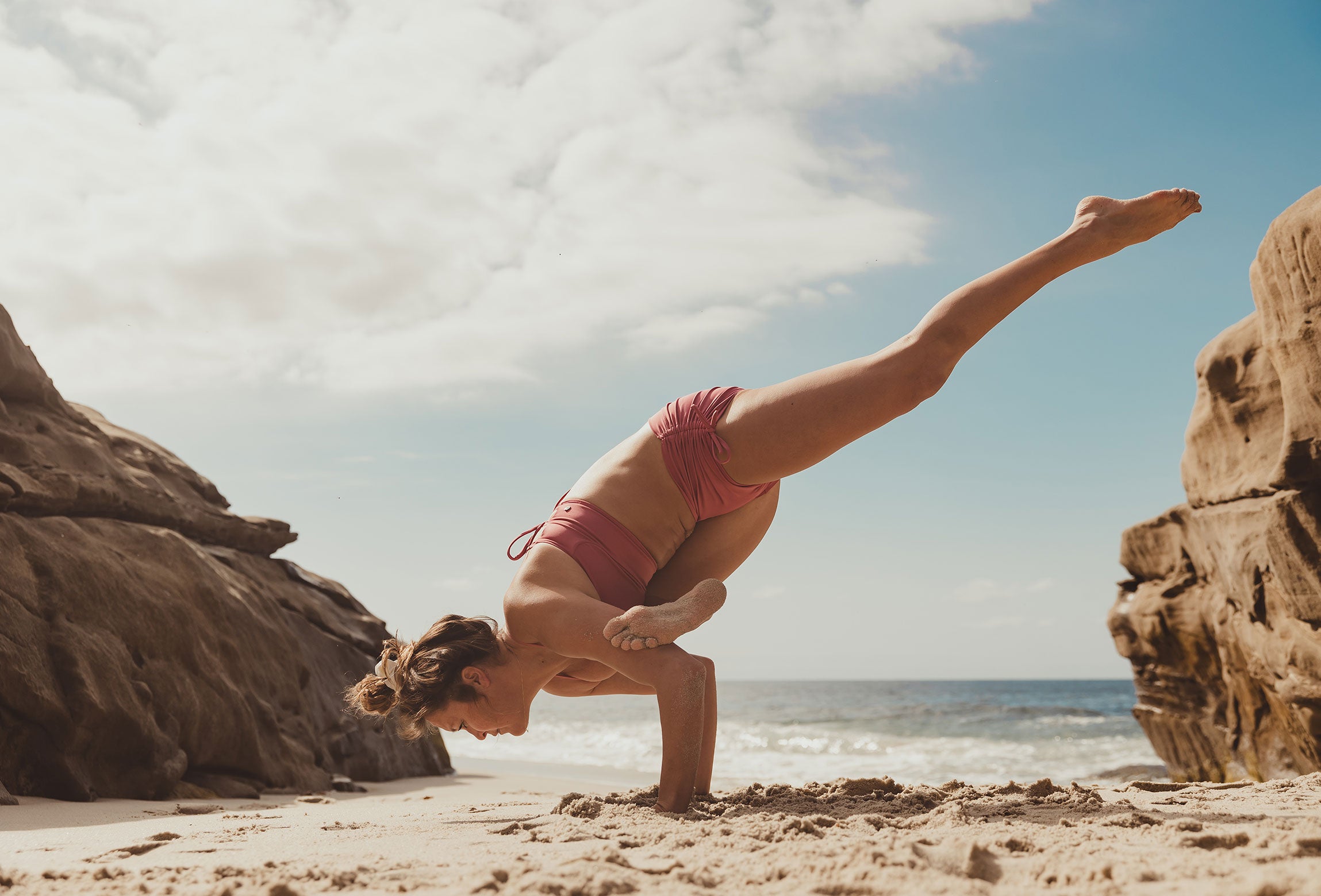 Model doing a yoga pose wearing Mikaela Short in Blush color