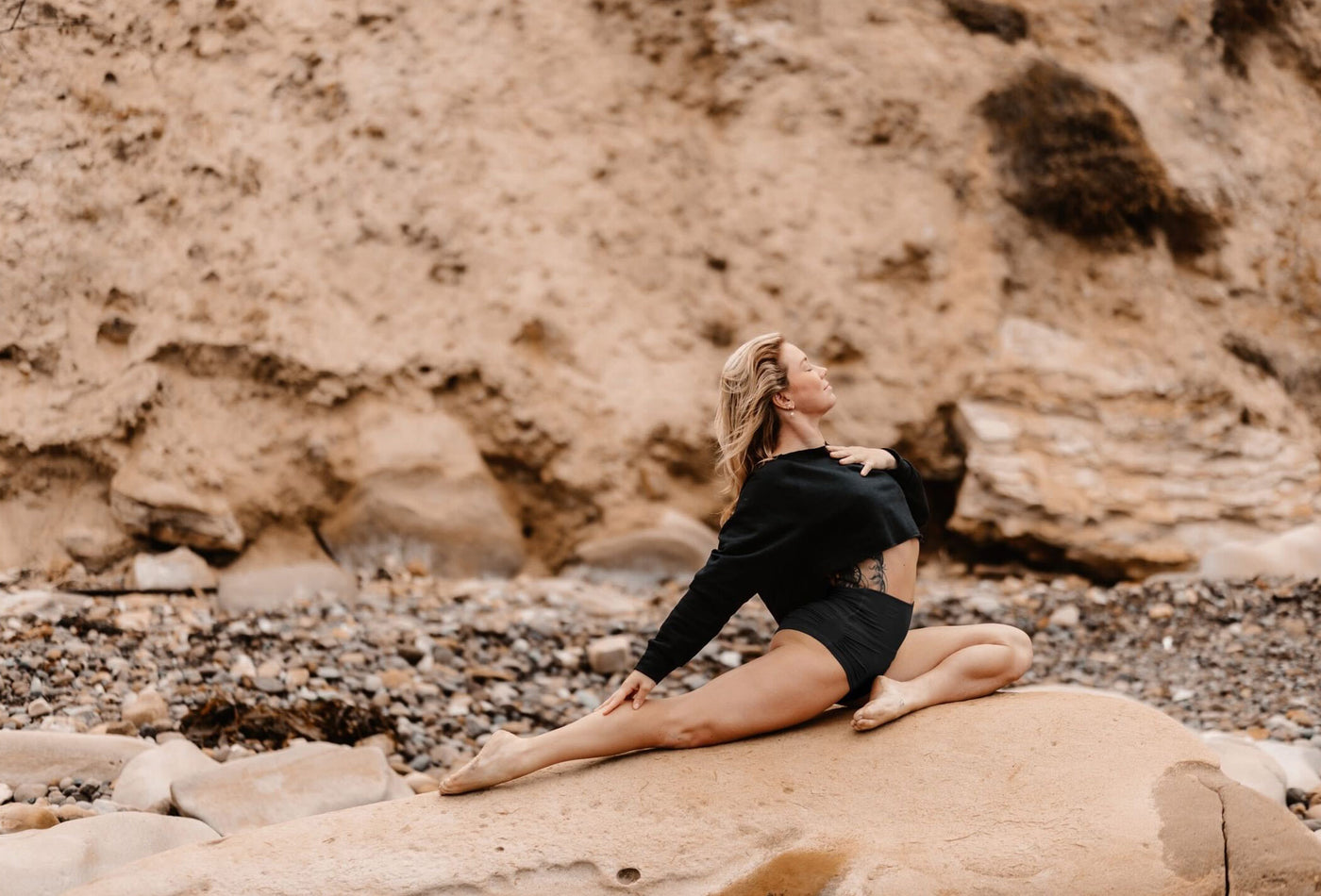 Model doing a yoga pose wearing Betty Short in black