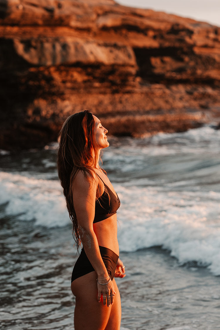 Model on the beach wearing Meeko Short in black