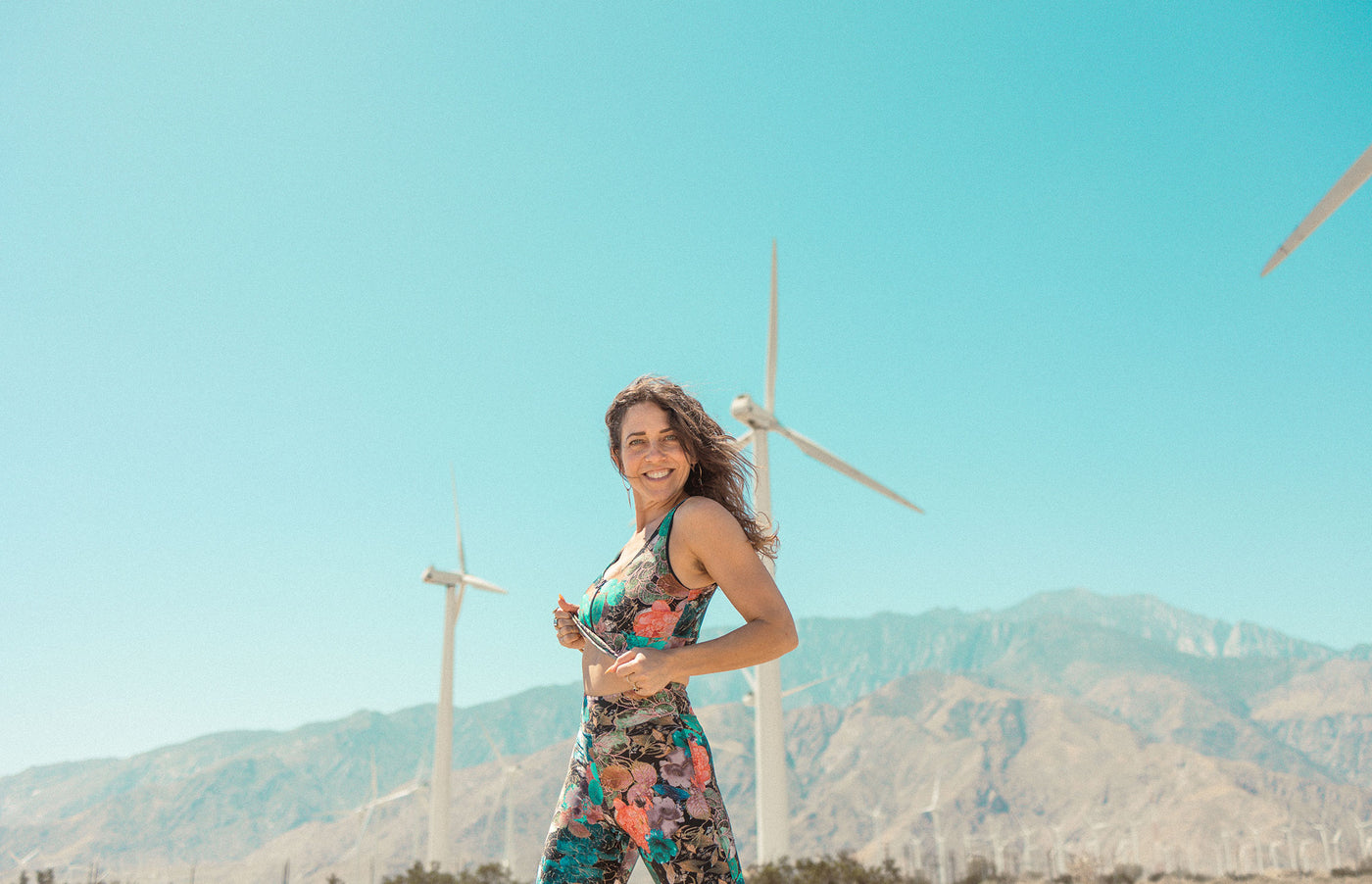 Model wearing Zoe Top with a windmill landscape in the background