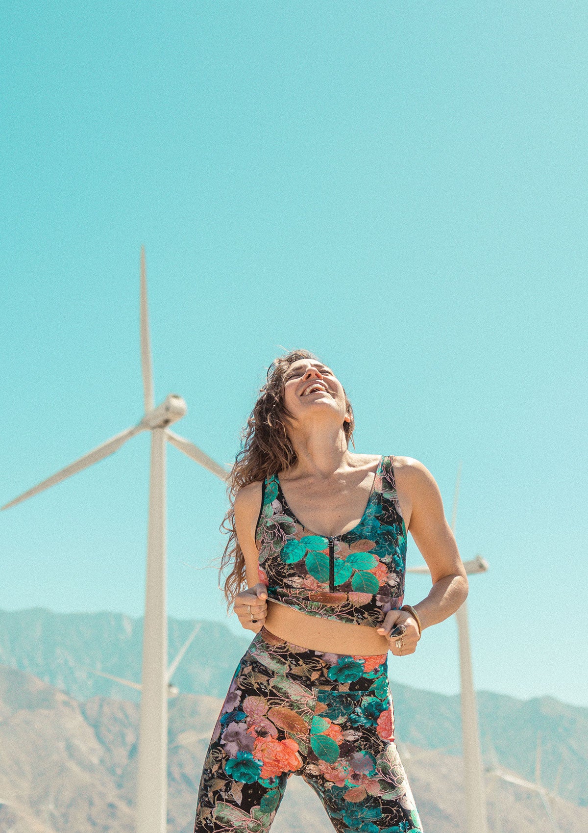 Model wearing Zoe Top with a windmill landscape in the background
